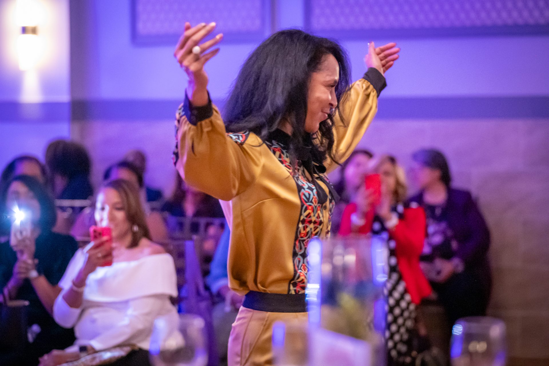 Businesswoman celebrating on the runway at the Women Driving Business fashion forum in Houston