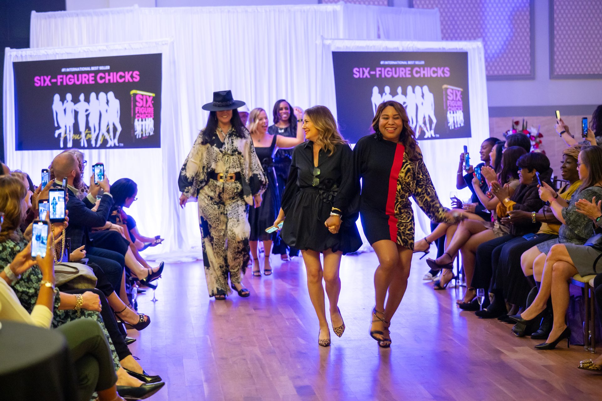 Houston businesswomen walking the runway at a Women Driving Business fashion forum